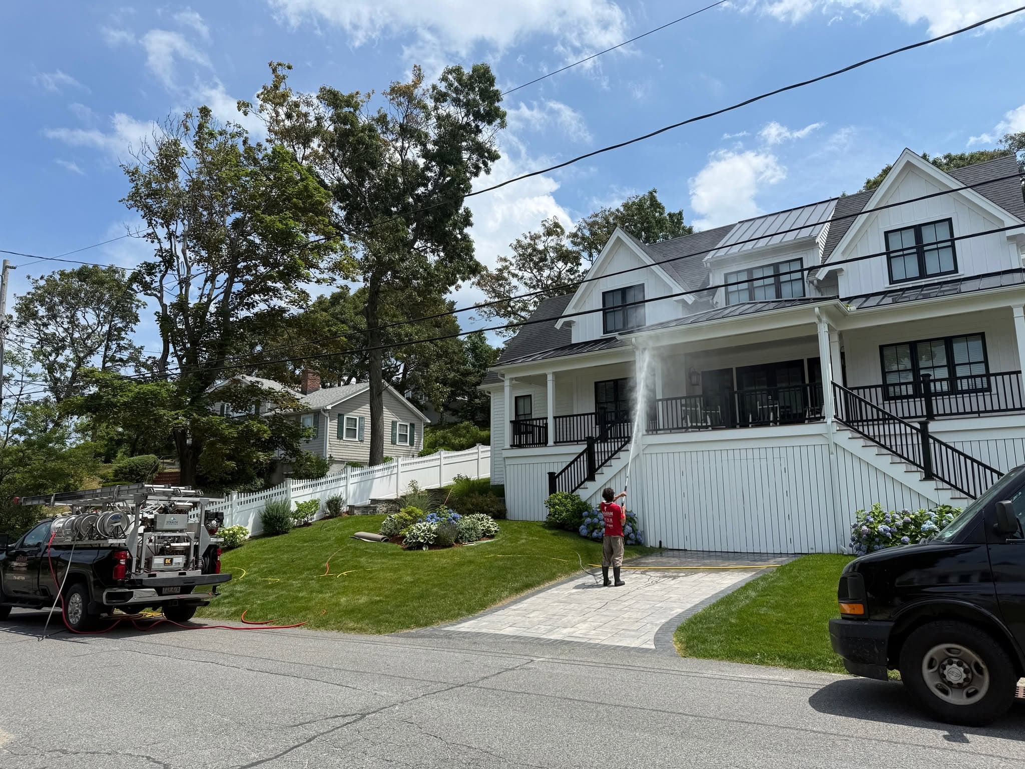 Graham Power Washing crew soft washing a home in Plymouth MA